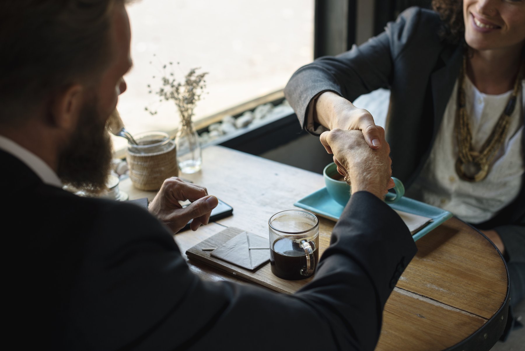 Business Handshake at a Desk